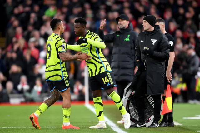 Nketiah embraces Jesus as he takes his place on the field.