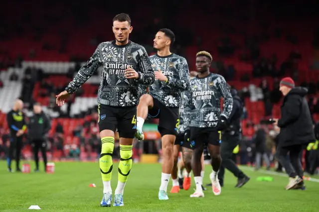 White leads the Arsenal players in a light jog in the warm up.