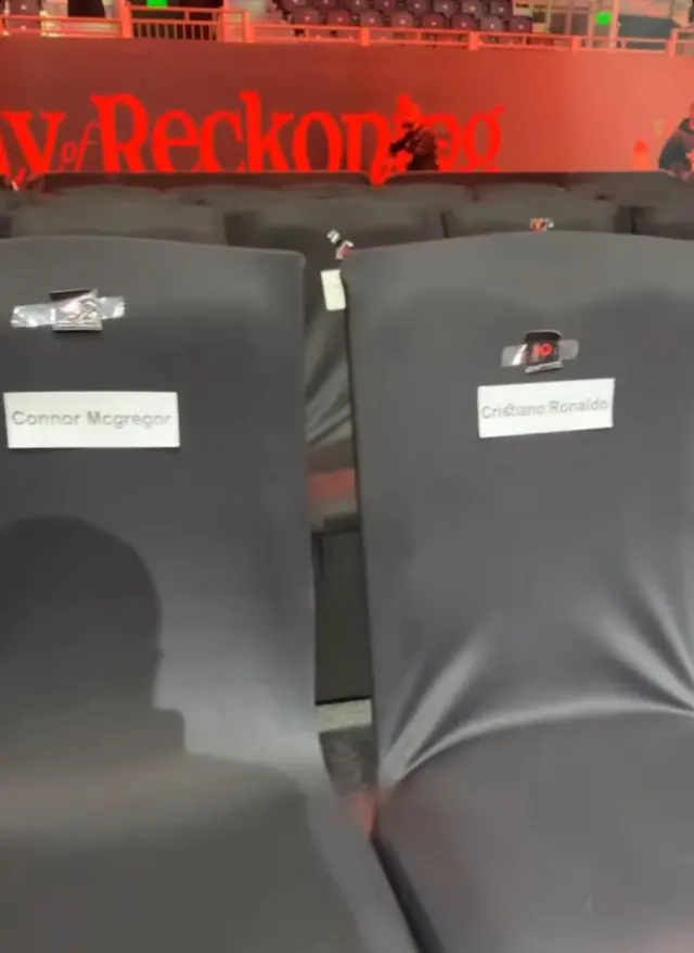 Two seats with the names of Conor McGregor and Cristiano Ronaldo written on labels