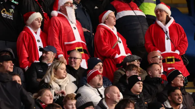 Fans dressed as Santa