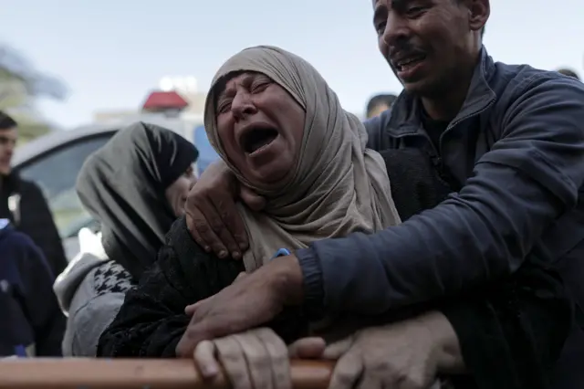 The mother of one of the Palestinians from the Barbakh family, who died during Israeli air strikes in the southern Gaza Strip, mourns outside Nasser Hospital in Khan Yunis, southern Gaza Strip, 22 December 2023