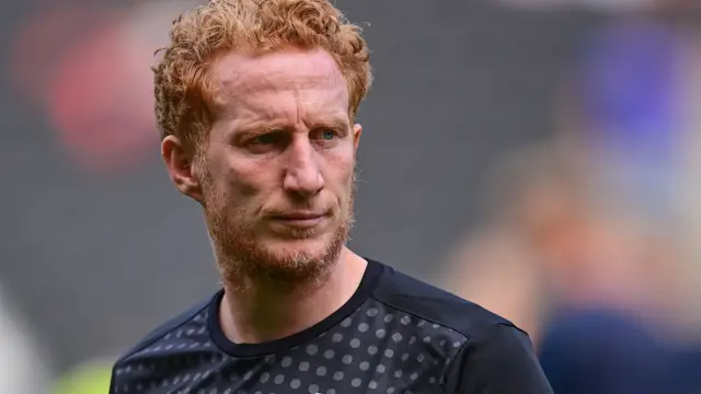 Dean Lewington warms up for MK Dons