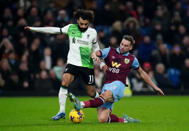 Charlie Taylor challenges Mo Salah as he tries to break away.