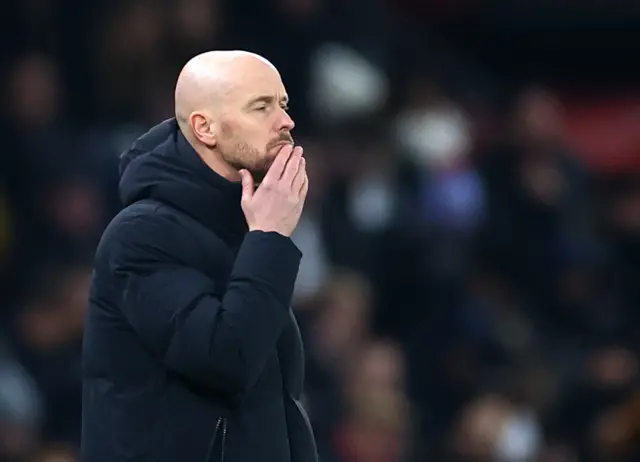 Ten hag rubs his chin in frustration.