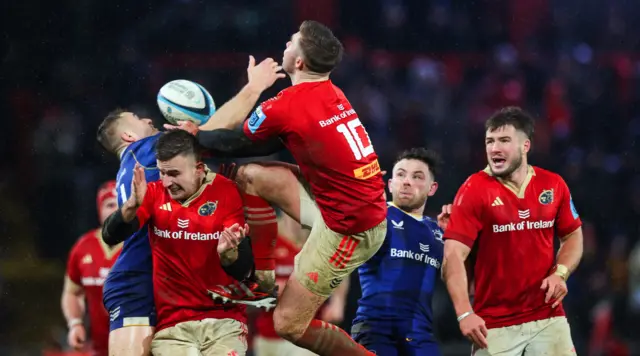 Leinster's Jordan Larmour and Jack Crowley contest the high ball