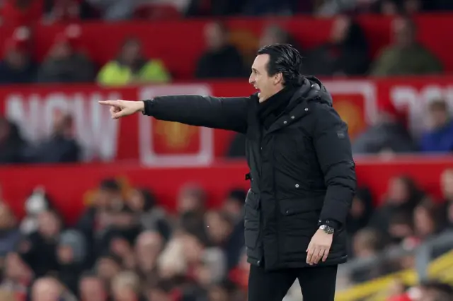 Emery points instructions to his players from the touchline.