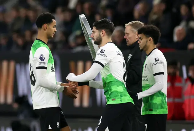 Liverpool players high five during a personnel swap.