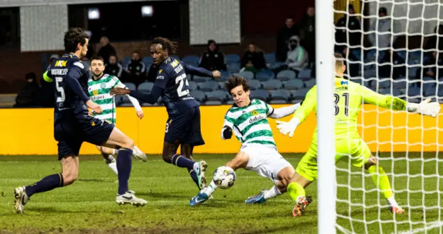 Celtic midfielder Paulo Bernardo opens the scoring at Dens Park, prodding the ball past Dundee goalkeeper Trevor Carson.