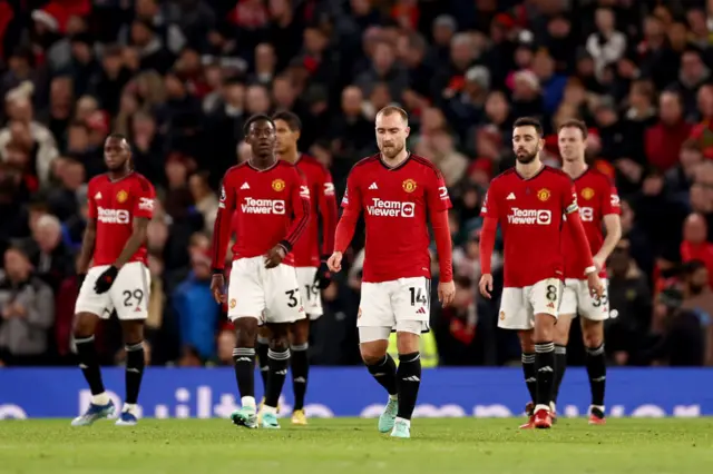 United players trudge back to kick off after conceding the second Villa goal.