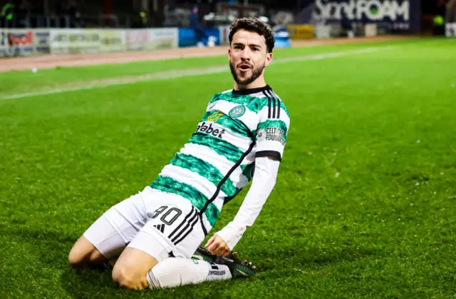 Celtic winger Mikey Johnston celebrates his first goal with a knee slide.