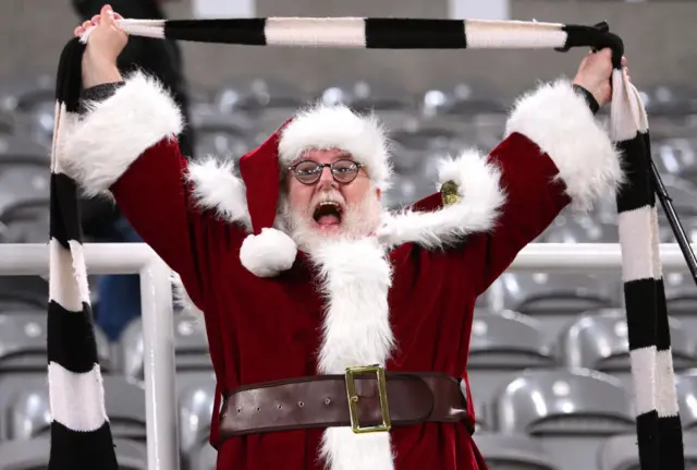 A Newcastle supporter dressed as Santa Claus