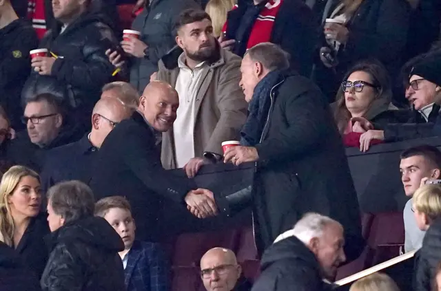 Dave Brailsford shakes hands with Patrick Stewart.