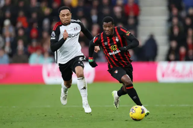 Dango Ouattara of AFC Bournemouth runs ahead of Kenny Tete of Fulham