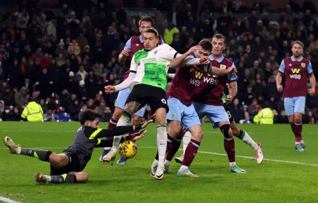 Trafford dives out at the feet of Nunez to claim the ball and deny a chance on goal.