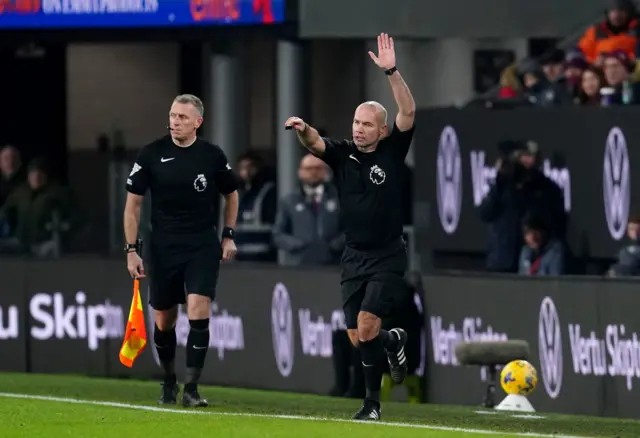 Paul Tierney indicates an offside in the second Liverpool goal after a VAR screen check.