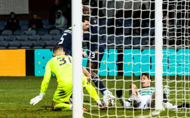 Celtic midfielder Paulo Bernardo opens the scoring at Dens Park, prodding the ball past Dundee goalkeeper Trevor Carson.