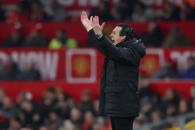 Emery holds his arms up and shouts in anger.