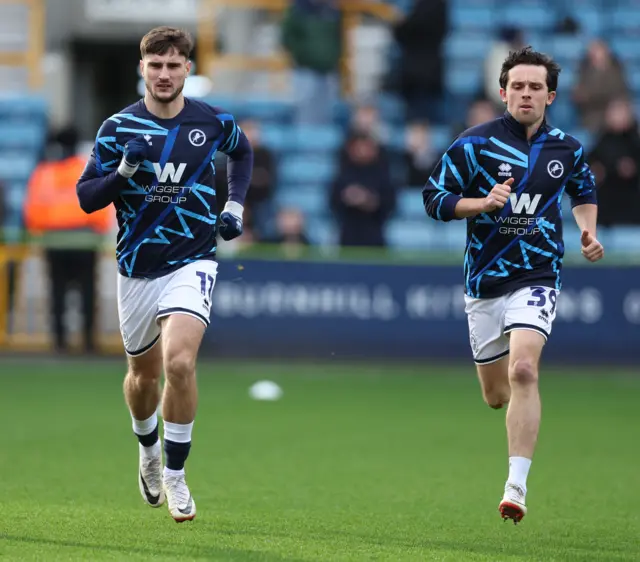 Millwall players warm up before the game against QPR