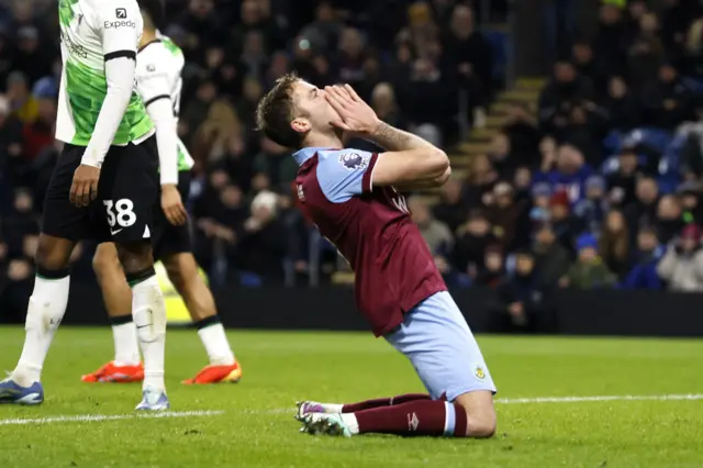 Gudmundsson puts his hands to his face in disbelief after missing a great chance.