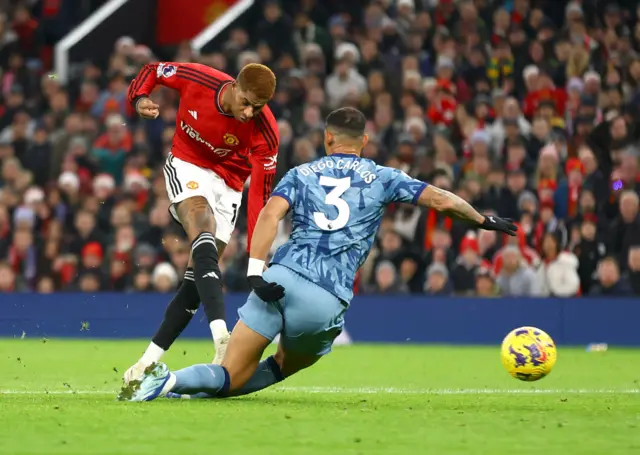 Rashford winds up a powerful shot in the box.