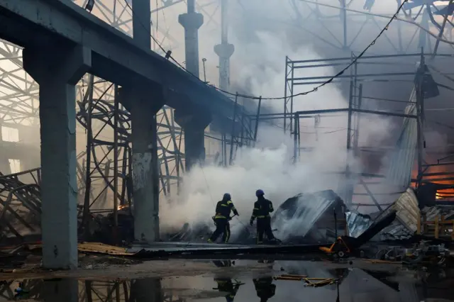 Firefighters at damaged warehouse in Kyiv