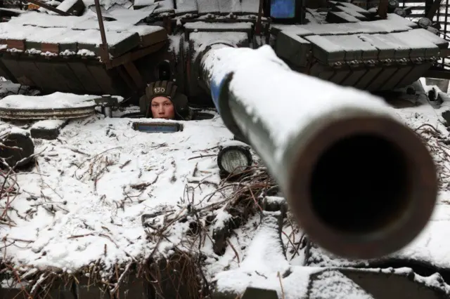 Ukranian soldier looking out of tank