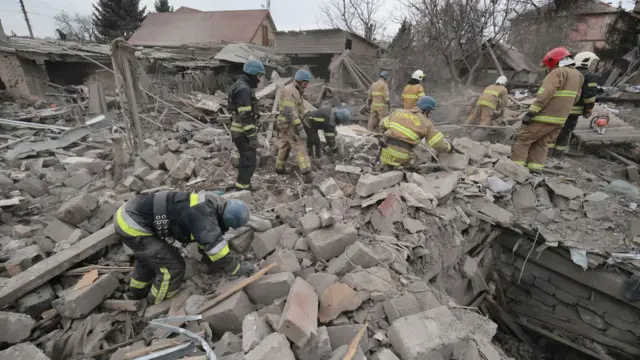 Emergency workers cleaning up rubble