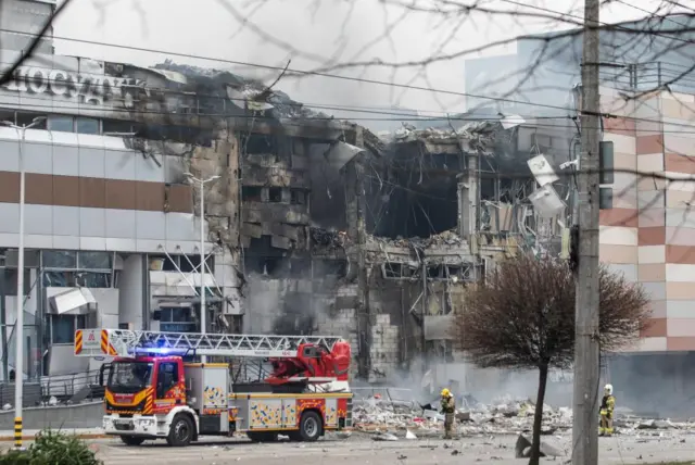 Emergency services work at the site of an overnight rocket attack on a shopping mall in Dnipro