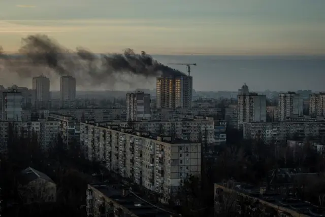 Smoke rises over a residential building after a Russian missile and drone strike in Kyiv