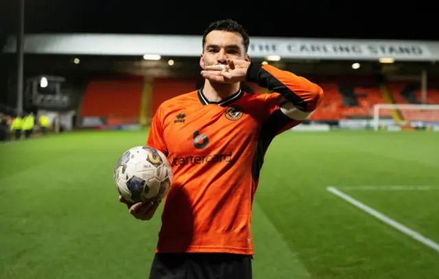 Tony Watt celebrates his hattrick with the match ball