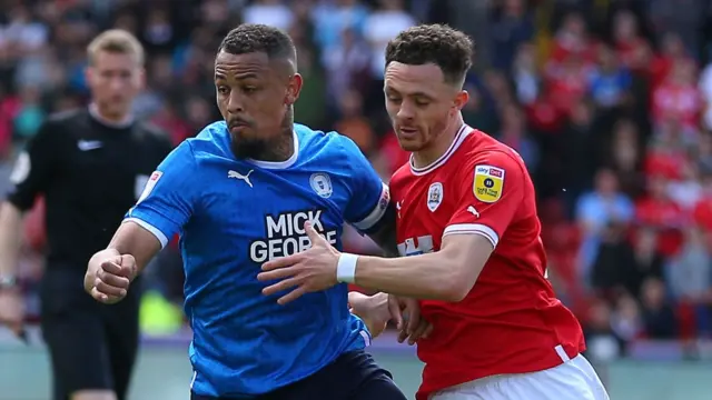 Peterborough forward Jonson Clarke-Harris and Barnsley defender Jordan Williams