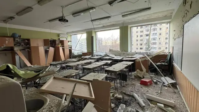 Lviv classroom with its windows shatttered, glass and other debris are strewn accross the room