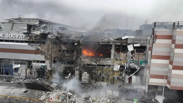 Destruction in Dnipro with a fire in the middle of a building