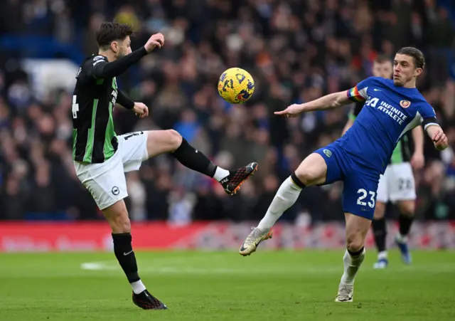 Adam Lallana battles for possession with Conor Gallagher