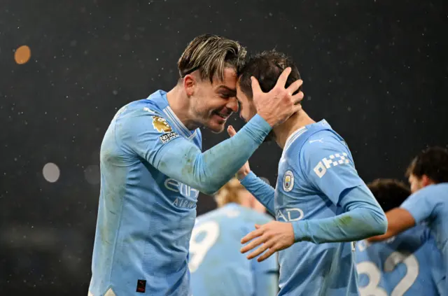 Jack Grealish celebrates with teammate Bernardo Silva