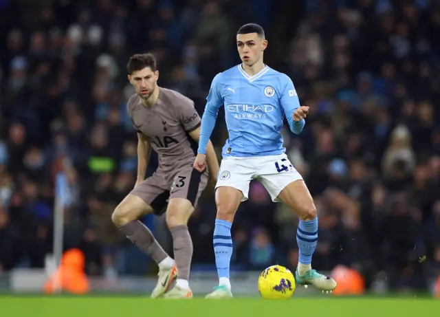 Ben Davies in action with Phil Foden