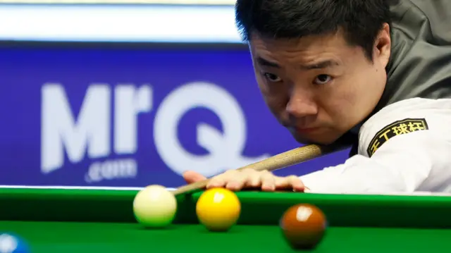 Ding Junhui plays a shot