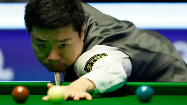 Ding Junhui plays a shot