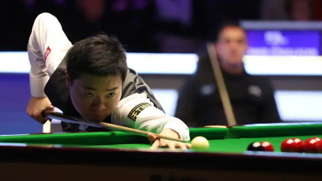 Ding Junhui plays a shot