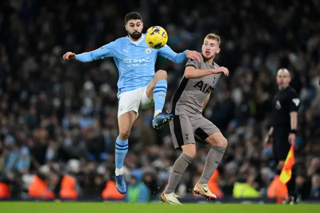 Josko Gvardiol jumps for the ball against Dejan Kulusevski