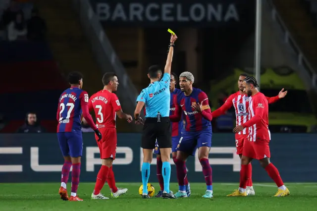 Ronald Araujo is shown a yellow card