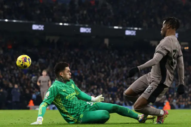 1 Ederson makes a save at the feet of Destiny Udogie