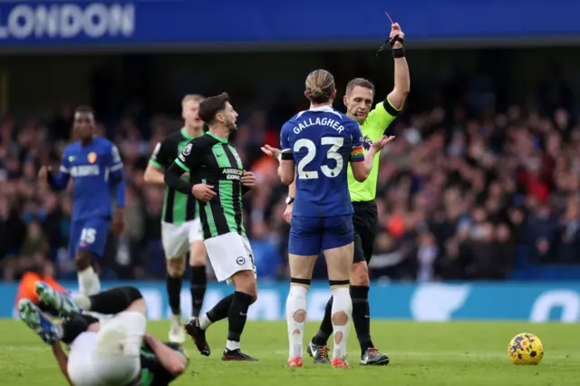 Craig Pawson shows a red card to Conor Gallagher