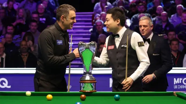 Ronnie O'Sullivan and Ding Junhui with the UK Championship trophy