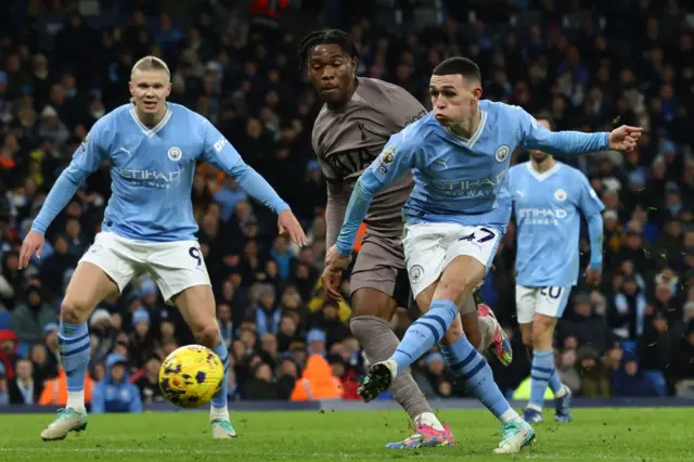 Phil Foden shoots to score their second goal