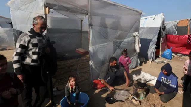 Displaced family sheltering in tent in Rafah