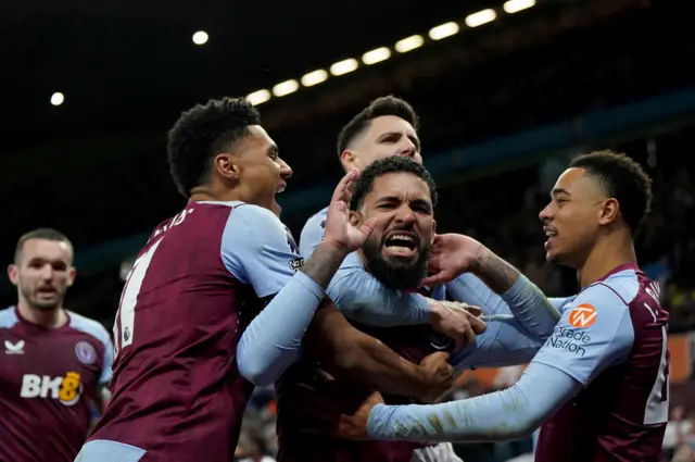 Douglas Luiz celebrates