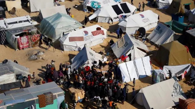 Displaced Palestinian children, who fled their homes due to Israeli strikes, shelter in a tent camp, amid the ongoing conflict between Israel and the Palestinian Islamist group Hamas, in Rafah, southern Gaza Strip, December 29, 2023.