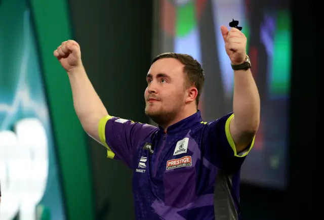 Luke Littler celebrates beating Raymond van Barneveld