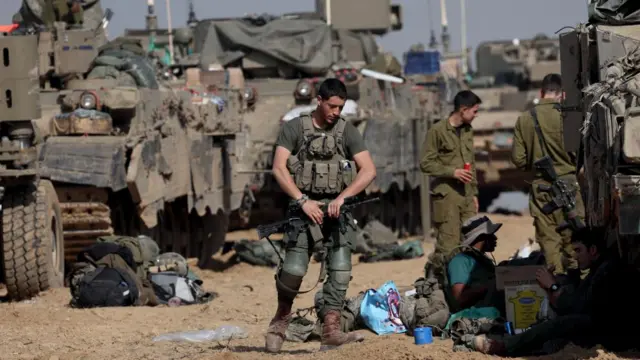 Israeli troops gather near the Gaza boundary on Sunday 3 December